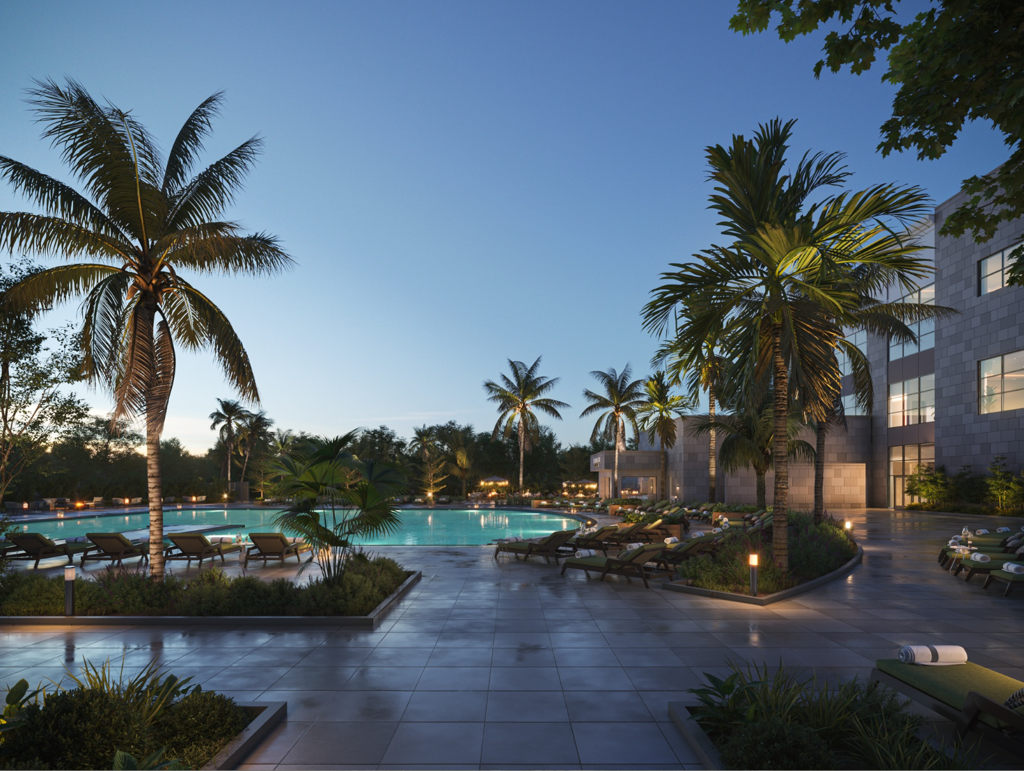 Resort pool deck lined with palm trees at dusk